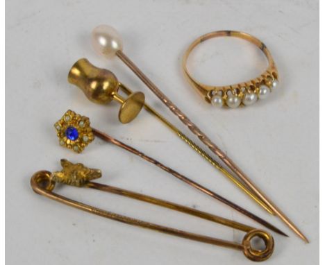 A small collection of jewellery comprising three stick pins, a brooch with a fox's head, and a dress ring set with five seed 