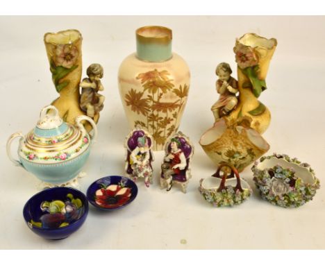 A pair of early 20th century Austrian amphora vases decorated with floral motifs and with figure of a boy playing an instrume