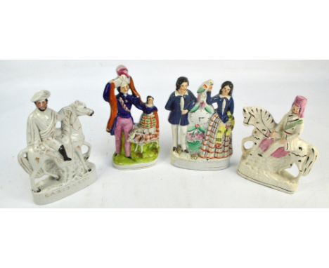 Two Victorian Staffordshire equestrian figures, one titled "Garibaldi", height 26cm, a figure group of a couple flanking a cl