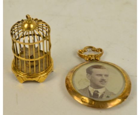 A 14ct yellow gold pendant modelled as a bird cage, height 3cm, and a 9ct yellow gold mounted circular double sided portrait 