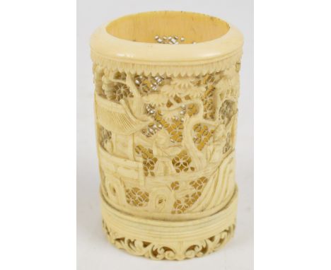 A 19th century Chinese carved ivory tusk vase depicting a continuous architectural landscape with figures, raised on oval fol