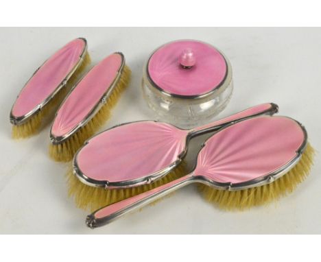 A George VI hallmarked silver mounted and pink guilloche enamel backed five piece dressing table set comprising two pairs of 