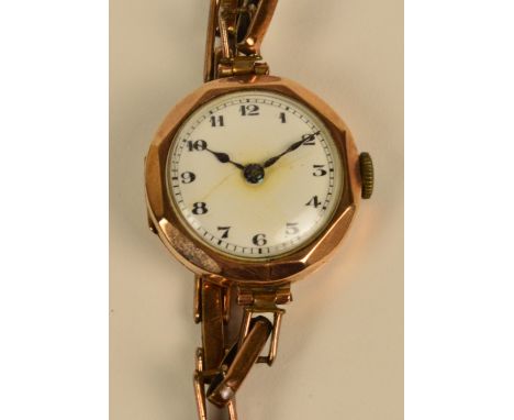 A lady's vintage 9ct gold cased wristwatch, the circular enamel dial set with Arabic numerals on expandable strap, unnamed.
