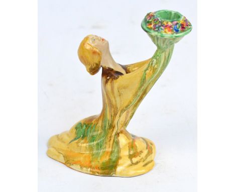 A c.1937 Clarice Cliff girl candlestick, shape 431, with painted flower bouquet and drip painted clothing, stamped on base wi