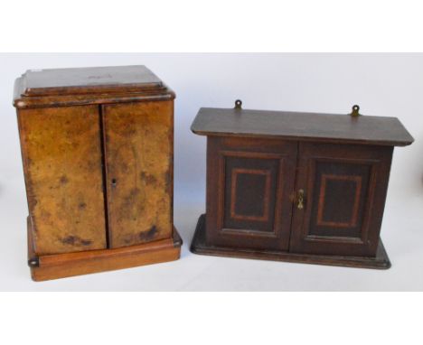 A Victorian walnut miniature chest on associated plinth, the two hinged doors enclosing four drawers with brass inset handles