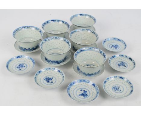 A 20th century Chinese matched set of six rice bowls with covers and saucers, painted in underglaze blue with floral sprays a