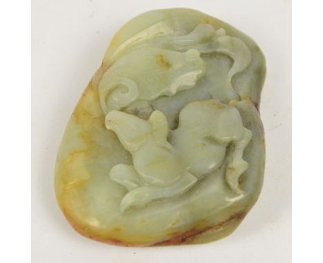 A 20th century Chinese jade pebble carved with water buffalo and foliage, with drilled suspension hole, 7 x 5cm.