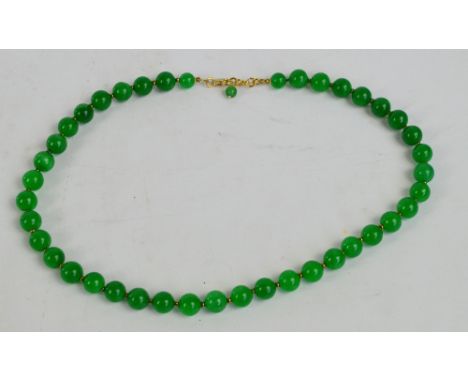 A jade bead necklace, length 48cm.