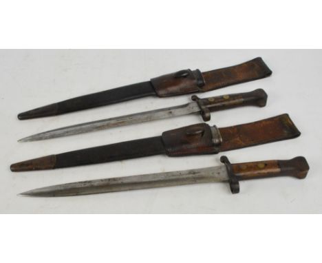 A pair of WWI period bayonets in scabbard, length 45cm.