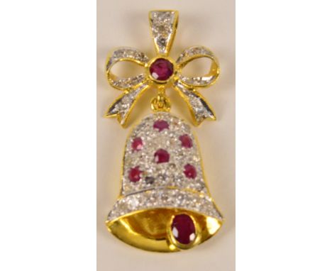 A yellow metal (tests as 18ct gold) ruby and diamond set bell shaped pendant, with swinging "clapper" beneath ribbon tied bow