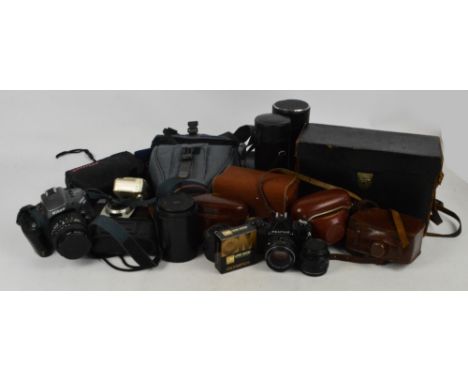 A quantity of photographic equipment including various lenses, a Nikon camera, a cased Bienette camera, etc.