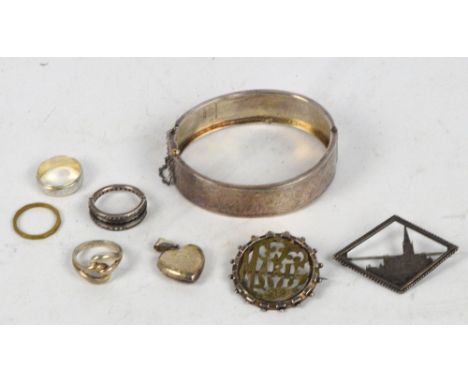 A small quantity of jewellery including a hallmarked silver snap bangle engraved to one side, a silver ring, a silver heart p