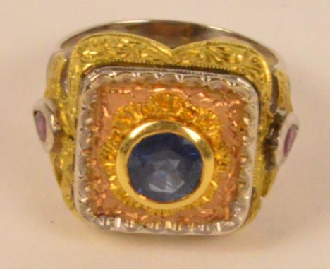 CAZZANIGA OF ROME; an 18ct three tone gold ruby and sapphire ring, the square section platform centred with a circular sapphi