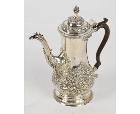 A George III hallmarked silver baluster coffee pot embossed with floral and scroll motifs to the lower part of the body and t