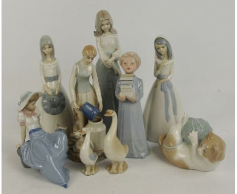 A group of Nao and Nao type figures including a seated girl beside a bird, a kitten playing with a ball of string (af) etc (9