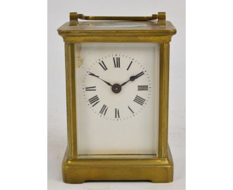 An early 20th century French brass cased carriage clock with swing loop handle, rectangular enamelled dial, Roman numerals an