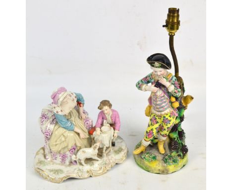 A large late 19th century Continental porcelain group of a young boy beside his mother with dog by their feet, on gilt height