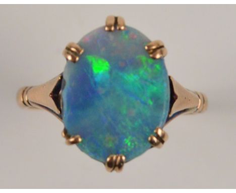 A 9ct gold dress ring set with an oval opal in high claw setting, size N, approx 3.1g. CONDITION REPORT: Opal is chipped on s