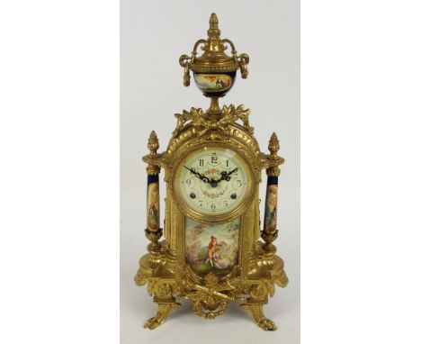 A decorative gilt metal mantel clock with porcelain panel and columns, the circular dial set with Arabic numerals, height 41c