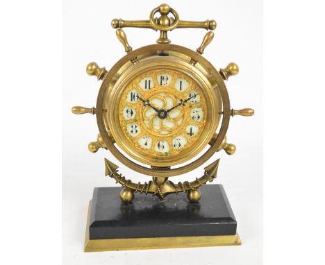 An early 20th century German brass cased timepiece modelled as a ship's clock within a ship's wheel border and on a stand mod