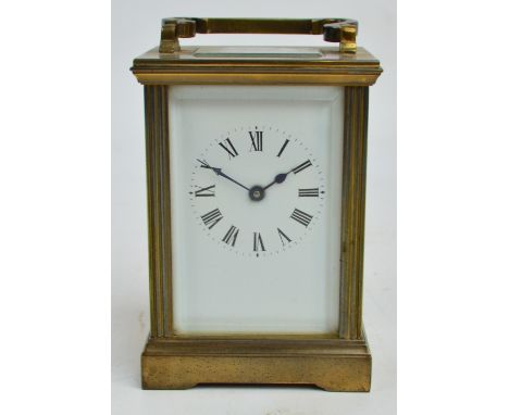 A Swiss brass carriage clock, the circular chapter ring set with Roman numerals, with presentation plaque to the back inscrib