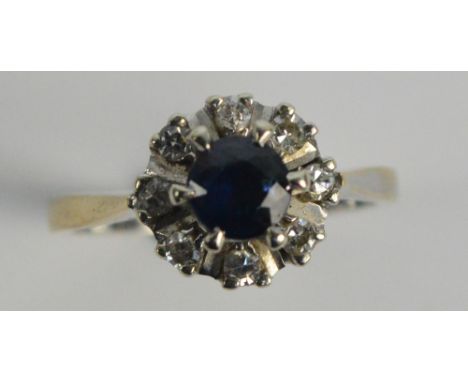 An 18ct white gold sapphire and diamond cluster ring, hallmarked for London 1978, size L.