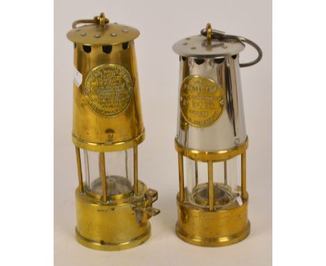A brass miner's lamp bearing a plaque "The Protector Lamp and Lighting Co Ld Eccles Manchester", height 27cm, and a brass and