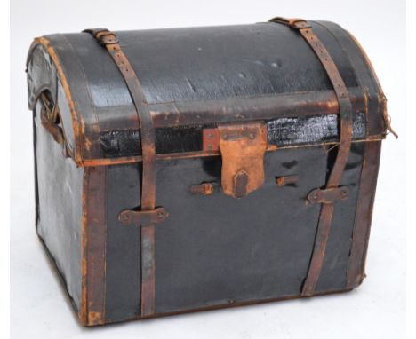 A leather strap bound domed trunk.
