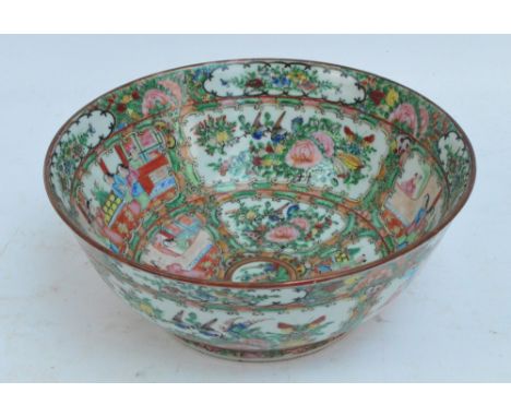 A 19th century Canton Famille Rose bowl enamel painted to the exterior and interior with figures and floral sprays within vig