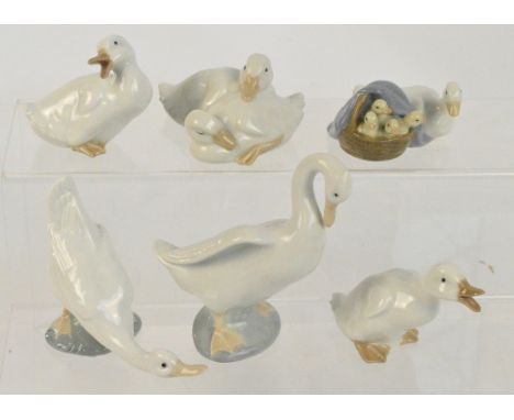 A Lladro figure group of a goose and goslings, four further Nao figures of geese, and another figure of a swan (6).