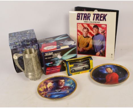 A collection of Star Trek memorabilia including a Star Trek calendar 1995, a Star Trek The Next Generation alarm clock, video