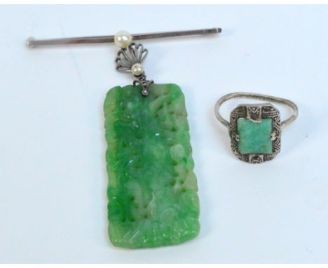 A jade brooch of rectangular form carved with various birds, suspended on pearl decorated 9ct white gold bar, and a white met