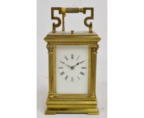 A c.1900 French carriage clock, the swing loop handle above rectangular white enamel dial set with Roman numerals flanked by 