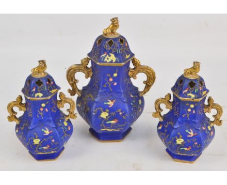 A mid 19th century English three piece garniture in the Oriental manner, the larger twin handled octagonal baluster shaped ja