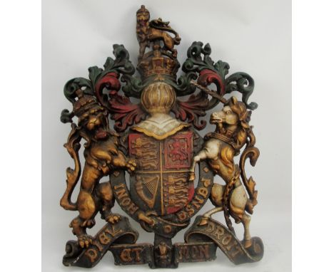 A 19th century painted cast iron coat of arms with lion, unicorn, and central shield, height 78cm, width 57cm.