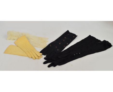 A small collection of vintage evening gloves comprising a pair of black satin elbow gloves embroidered with flower buds, a pa
