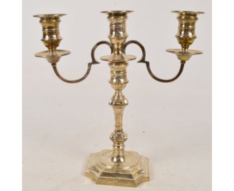 An Elizabeth II hallmarked silver candelabrum/candle holder, the detachable upper section set with three sconces of square se