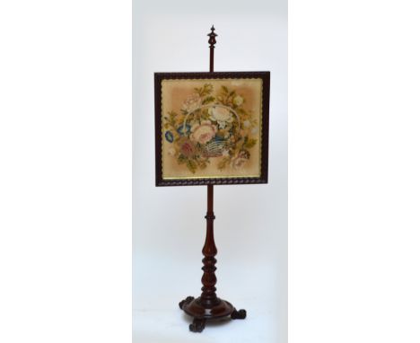 A Victorian mahogany pole screen with square section floral tapestry panel.
