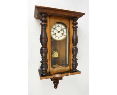 A small stained beech Vienna style spring driven wall clock with two piece white enamel dial, length approx 68cm. CONDITION R