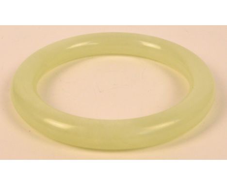 A Chinese jade bangle of pale green colour, diameter 8cm. CONDITION REPORT: Condition is good.