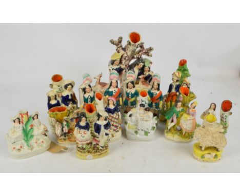 A collection of late 19th century and reproduction Staffordshire spill vases, also a pair of reproduction clock groups.