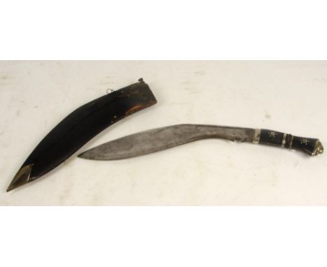 A good kukri knife in scabbard.