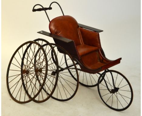 A vintage leather three wheeled pushchair in wooden frame, length 110cm including front wheel and handle, also a pair of spar