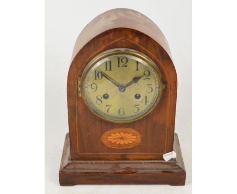 An Edwardian mahogany and inlaid dome topped mantel clock with circular dial set with Arabic numerals above stepped base, hei