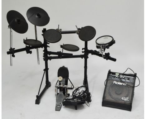 A Roland electric drum set with amplifier. CONDITION REPORT: Heavy wear. Model no.TD-6V. We are not able to test as to whethe