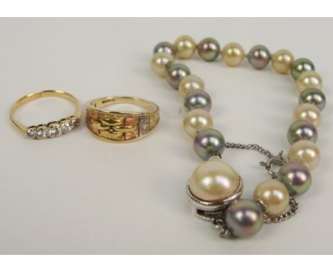 A 9ct three tone gold ring, an 18ct five stone diamond ring and a simulated pearl bracelet (3).