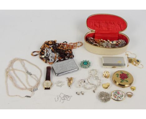 A small quantity of costume jewellery including predominantly brooches, three simulated pearl bead necklaces, and others, a U