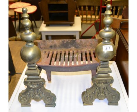 A pair of brass fire-dogs and a fire grate