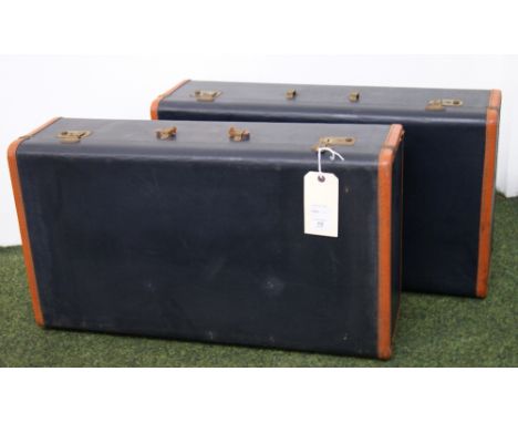 A pair of blue and tan vintage suitcases