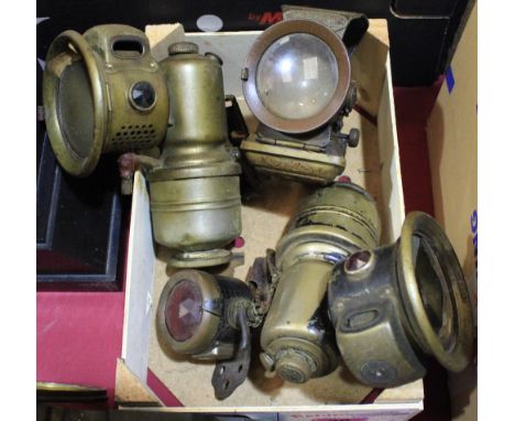 Automobilia. Two acetylene motorcycle lamps, a petroleum Silver King lamp and a Miller early electric tail lamp
